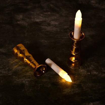 Close-up of a flameless LED candle light showing its realistic flicker and elegant gold base.
