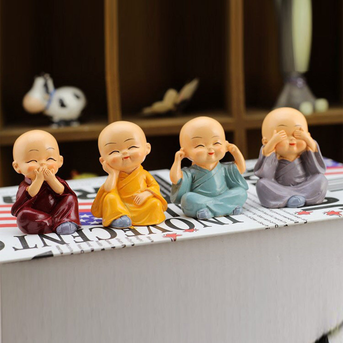 Four small Baby Buddha statues arranged elegantly, ideal for office or desk decoration.