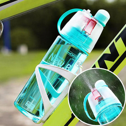 Hand holding the lightweight and portable 600ML spray water bottle.